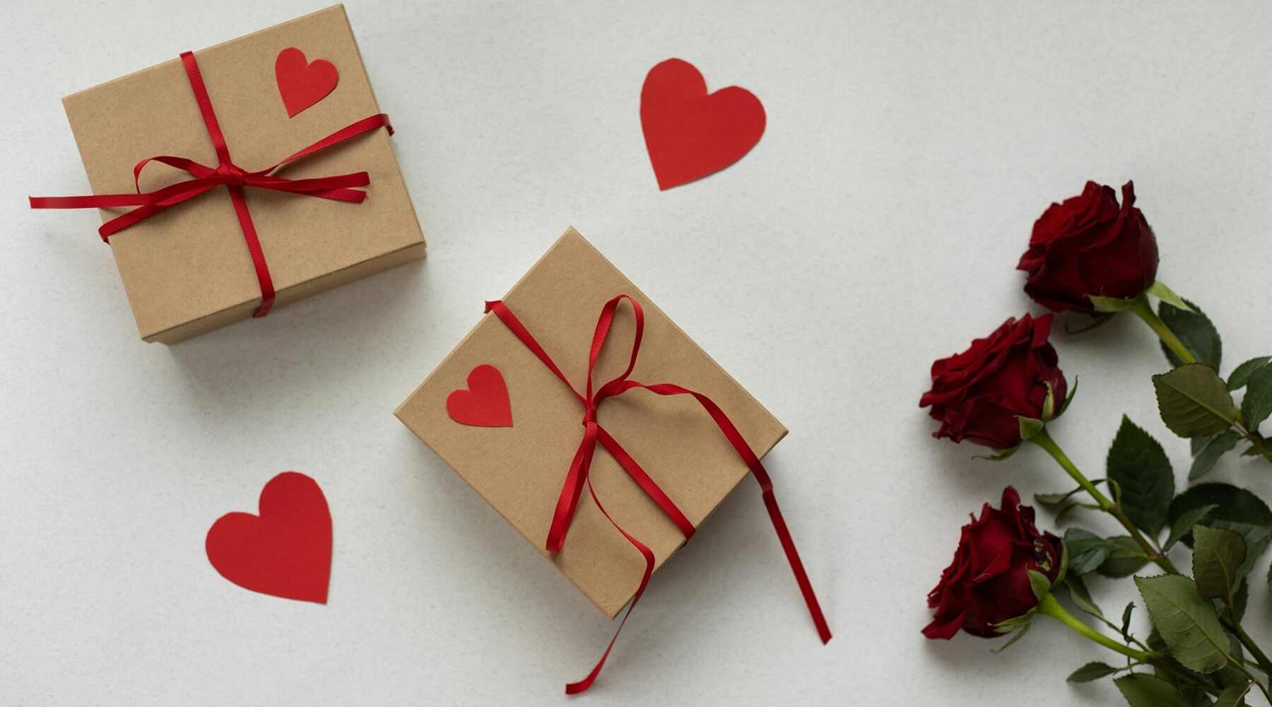 wrapped presents and a bouquet of red roses, highlighting Valentine's Day gift ideas that cat owners will love in 2025